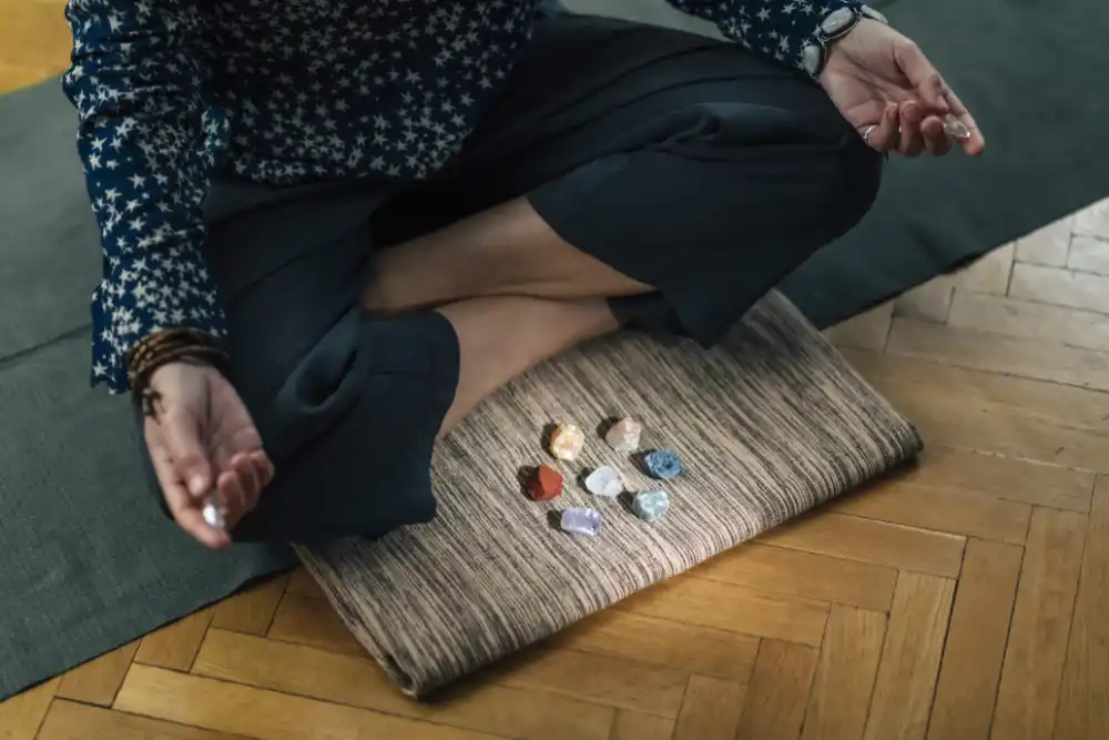 A meditation practitioner with the seven precious materials arranged on their meditation cushion before them